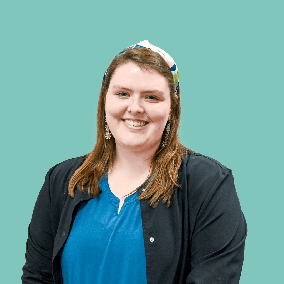 Kaitlyn Brooks, wearing a blue shirt and black scrubs